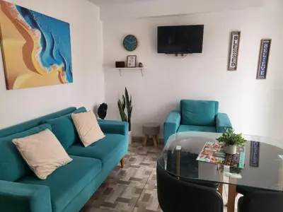 a living room with a blue couch and a glass table at Miel de Luna in Cerro Azul
