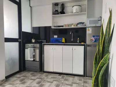 a kitchen with white cabinets and a stove at Miel de Luna in Cerro Azul