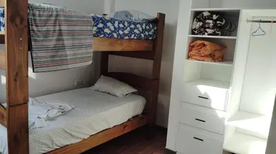 a bedroom with a bunk bed and white shelves at CASITA PARA FIN DE SEMANA in Chincha Baja