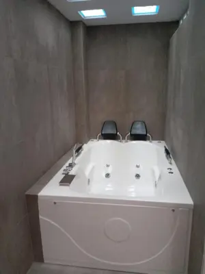 a bath tub with two chairs sitting on top of it at CASITA PARA FIN DE SEMANA in Chincha Baja