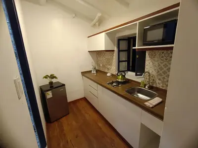 a small kitchen with a sink and a refrigerator at Mini Apart II - Sumaq Wasi ALBA in Cusco