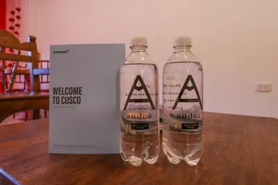 two bottles of water on a table next to a box at Casa Muru By Wynwood House in Cusco