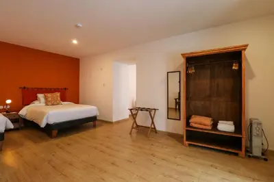 a bedroom with a bed and a chair in it at Casa Muru By Wynwood House in Cusco