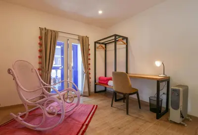 a room with two chairs and a table and a desk at Casa Muru By Wynwood House in Cusco
