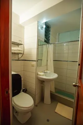 a bathroom with a toilet and a sink and a shower at Hotel Ruta Amazónica Machupicchu in Machu Picchu