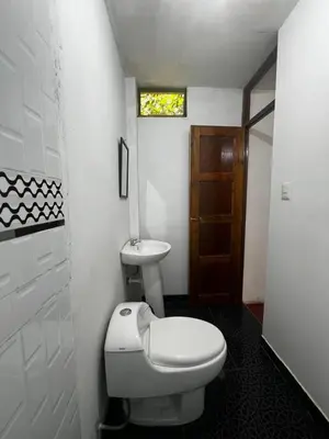 a bathroom with a toilet and a sink at Eco Inca Trail Lodge Lucmabamba in Cusco