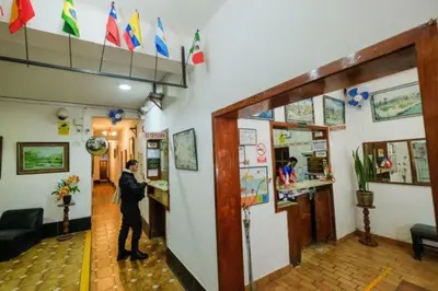 a man standing at a counter in a restaurant at Residencial San Felipe in Lima