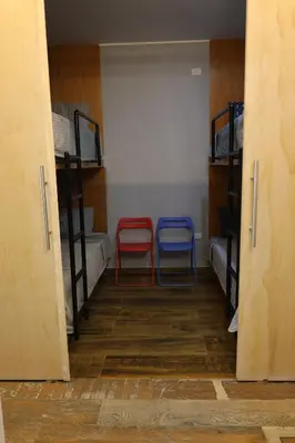 two red and blue chairs in a room with bunk beds at Casa sabina hostel in Lima