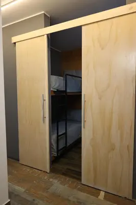 ajar door in a room with a bunk bed at Casa sabina hostel in Lima