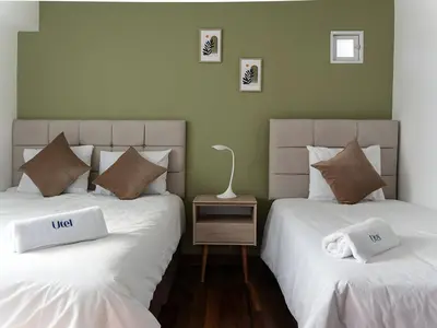 two beds sitting next to each other in a room at Acogedor 2BR Center Miraflores - Balta in Lima
