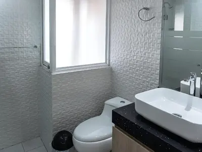 a bathroom with a white toilet and a sink at Acogedor 2BR Center Miraflores - Balta in Lima
