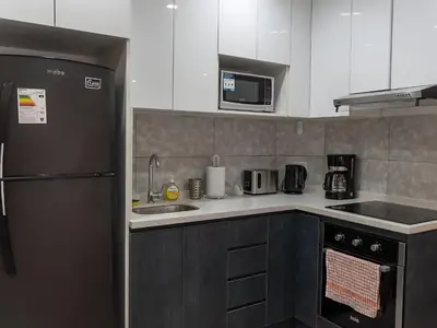 a kitchen with a refrigerator and a sink at Moderno 2BR Center Miraflores- Balta 301 in Lima