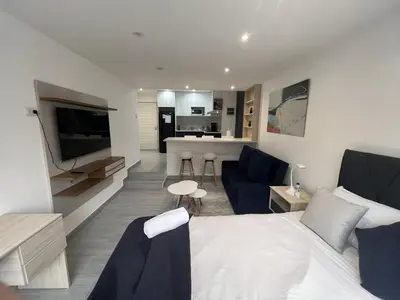 a living room with a bed and a kitchen at Moderno 2BR Center Miraflores- Balta 301 in Lima
