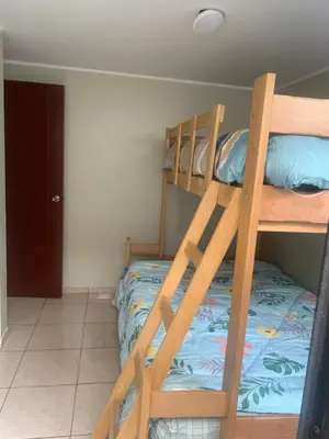 a bedroom with two bunk beds in a room at Apartamento LA ALBORADA para 7 con cochera in Huancayo
