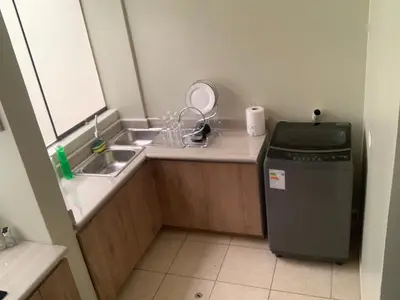 a small kitchen with a sink and a refrigerator at Apartamento LA ALBORADA para 7 con cochera in Huancayo