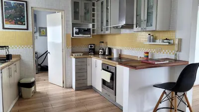 a kitchen with white cabinets and a counter top at Acogedor 2BR Miraflores - Tovar in Lima