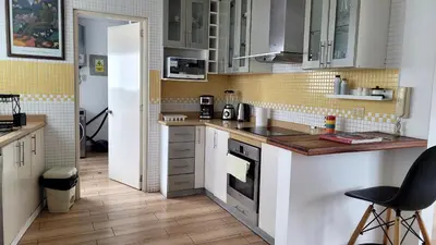 a kitchen with white cabinets and a stove top oven at Acogedor 2BR Miraflores - Tovar in Lima