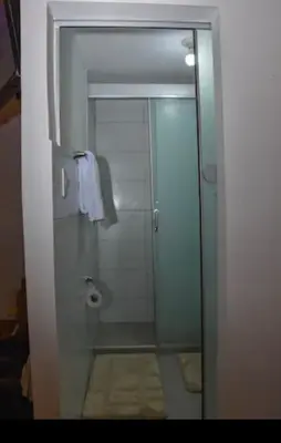 a bathroom with a shower with a glass door at Apu House Monoambiente in Cusco