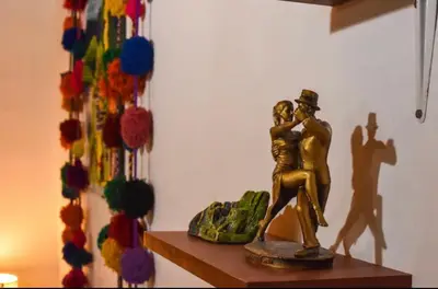a statue of a man and a woman on a table at Apu House Monoambiente in Cusco