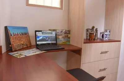 a laptop computer sitting on top of a wooden desk at Apu House Monoambiente in Cusco