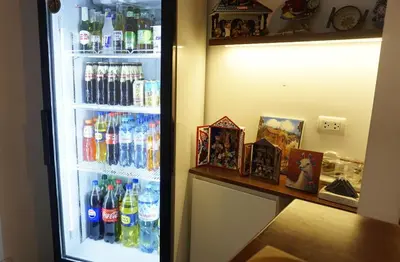 a refrigerator filled with lots of soda and drinks at APARTAMENTOS PRIVADOS Lima Airport Perú in Lima
