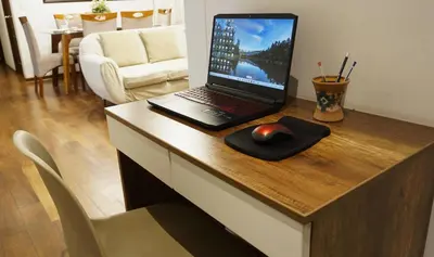 a laptop computer sitting on a desk with a mouse at APARTAMENTOS PRIVADOS Lima Airport Perú in Lima