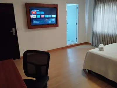 a room with a bed and a television on a wall at Casa Pucllana Miraflores - Hotel Boutique in Lima