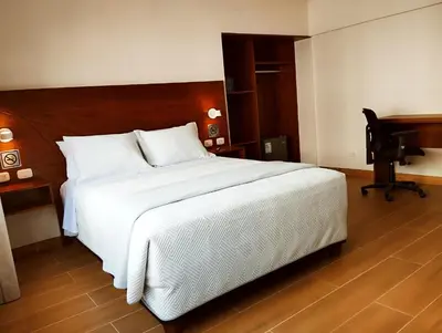 a bedroom with a large white bed and a piano at Casa Pucllana Miraflores - Hotel Boutique in Lima