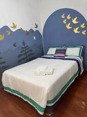 a bedroom with a bed with two towels on it at Puerta Azul Hospedaje in Lima