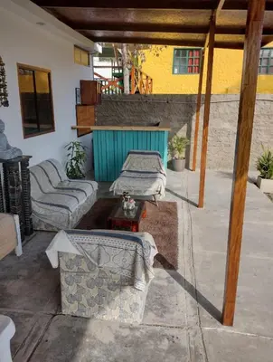 a patio with two couches and a table on a patio at Casita de Playa in Barranca