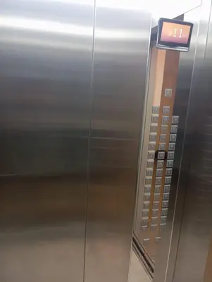 an elevator in an airport with a sign on it at Departamento en el edificio más alto del Perú, a 10 min de Plaza de Armas in Lima