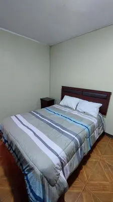 a bedroom with a large bed in a room at Carosvi Home in Lima