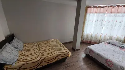 a bedroom with two beds and a window at Carosvi Home in Lima