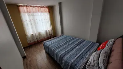 a small bedroom with a bed and a window at Carosvi Home in Lima