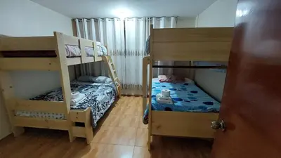a bedroom with two bunk beds and a small bed at Carosvi Home in Lima