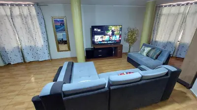 a living room with two couches and a flat screen tv at Carosvi Home in Lima