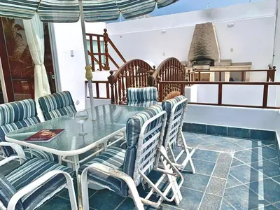 a dining room with a table and chairs at Casa entera con piscina y salida a la playa in Salinas