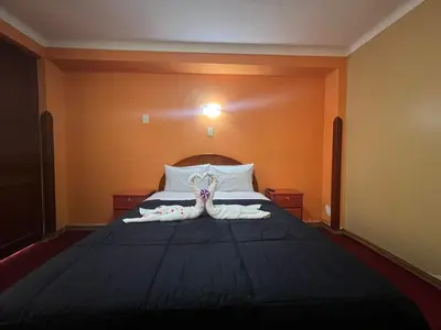 a bedroom with a bed with white towels on it at HOSTAL HUAYNA HOUSE GO in Cusco