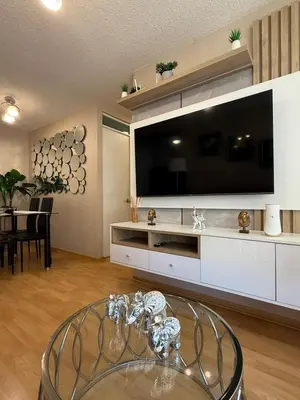 a living room with a large tv and a glass table at dos apartamentos cerca de la laguna de Huacachina in Ica