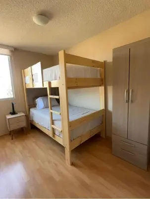 a bedroom with two bunk beds in a room at dos apartamentos cerca de la laguna de Huacachina in Ica