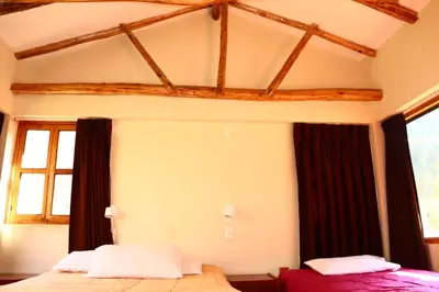 a bedroom with two beds in a room at Full Moon Eco Lodge in Ollantaytambo