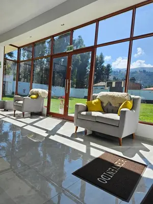 a living room with two couches and a rug at catañuñi in Huancayo