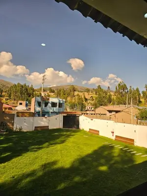 a view from the roof of a building with a green yard at catañuñi in Huancayo