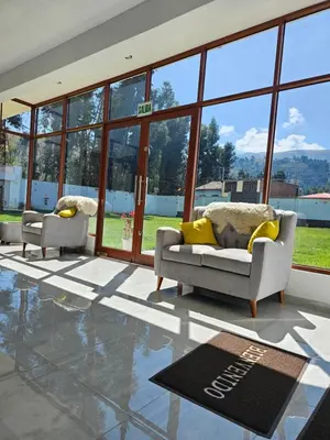 a living room with two couches and a rug at catañuñi in Huancayo