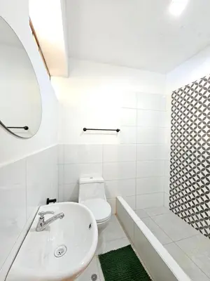 a white bathroom with a sink and a toilet at catañuñi in Huancayo