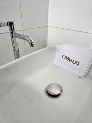 a bathroom sink with a towel and a drain at catañuñi in Huancayo
