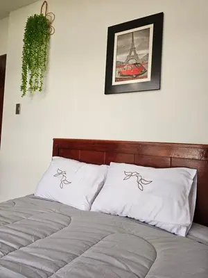 a bedroom with a bed with two pillows on it at catañuñi in Huancayo