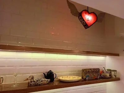 a shelf with a red heart hanging from a wall at Departamento boutique in Lima