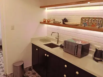 a kitchen with a sink and a microwave at Departamento boutique in Lima