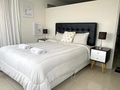 a bedroom with a large bed with two pillows on it at Departamento con vista de Lima in Lima